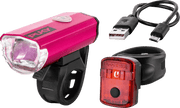 PUKY LUMI-setet består av en rosa LED-lampa framtill, en röd baklampa, en svart USB-kabel och två svarta monteringsremmar, allt på en vit bakgrund.